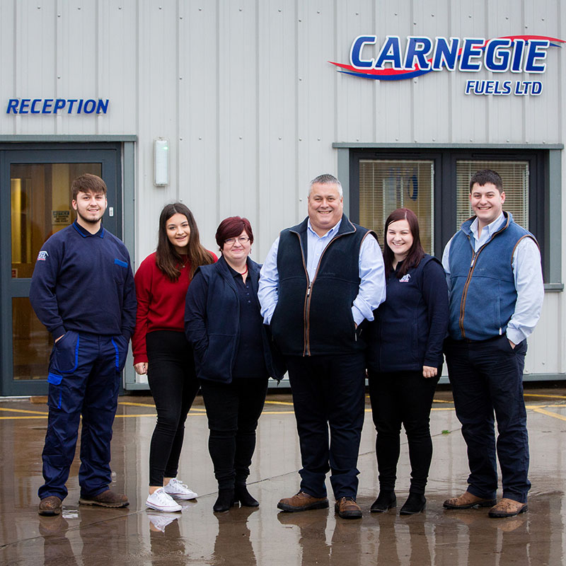 The Carnegie family standing in front of the Carnegie Fuels headquarters in Brechin